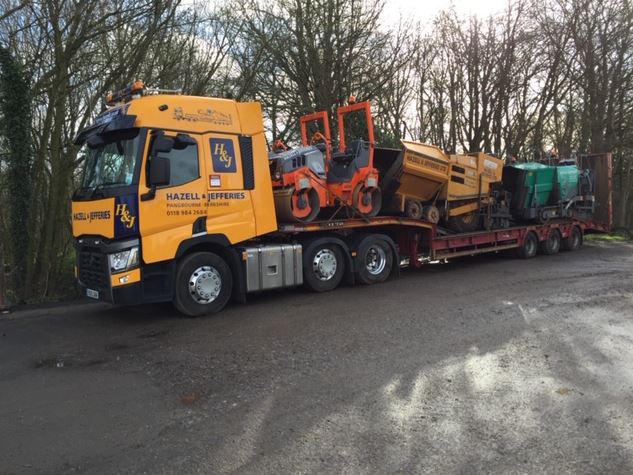 Size view of a Hazell & Jefferies lorry carrying driveway and path treatment machinery.