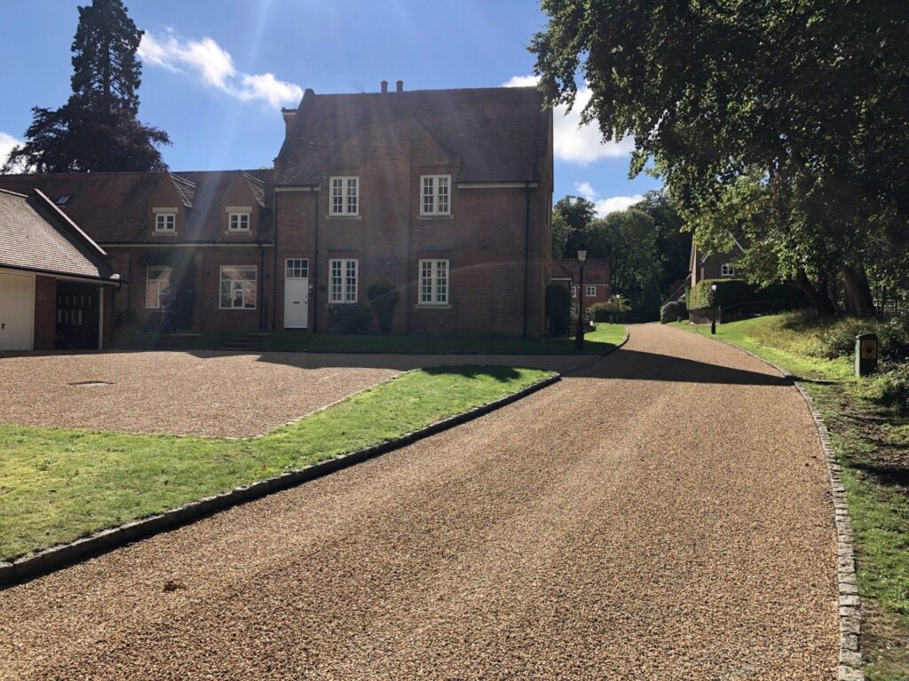 Newly surface dressed driveway proceeding to a large stately home.