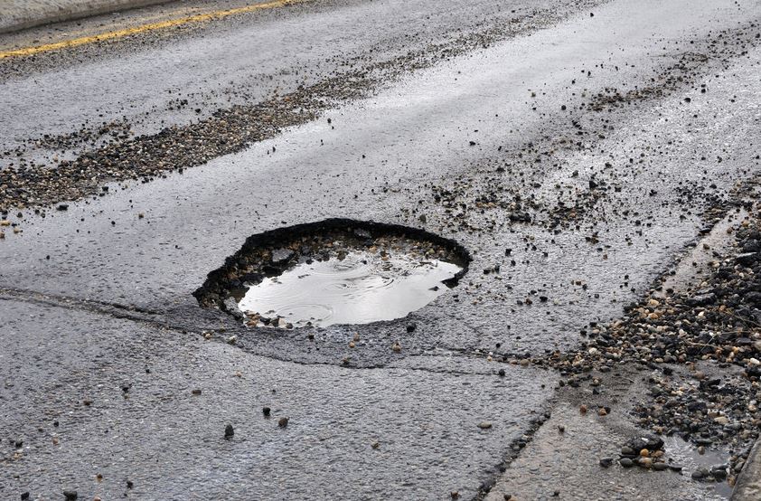 Large pot hole filled with water