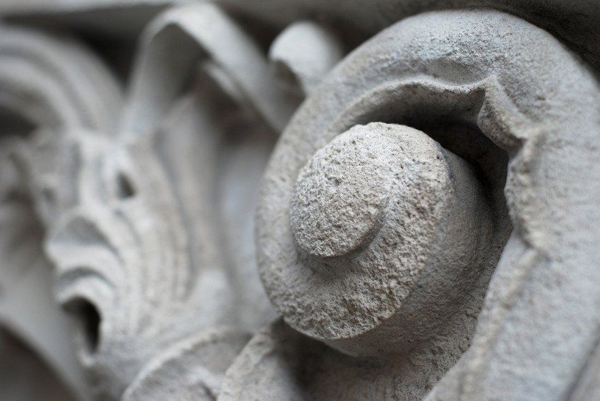 Super close up of a traditional garden statue or wall adornment.